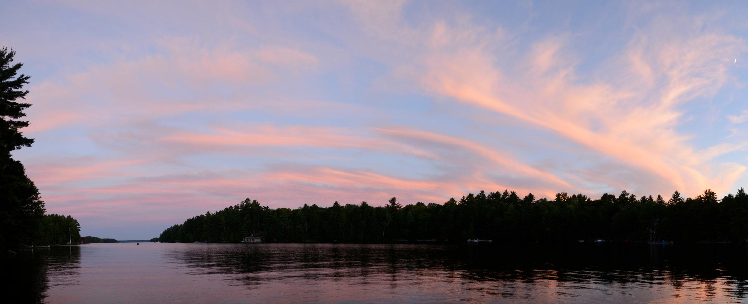 Pink sunset over forest and Lake Muskoka